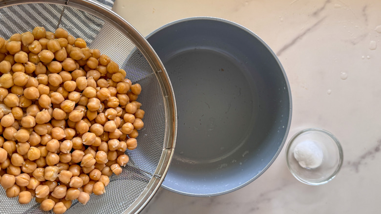 adding chickpeas to pot