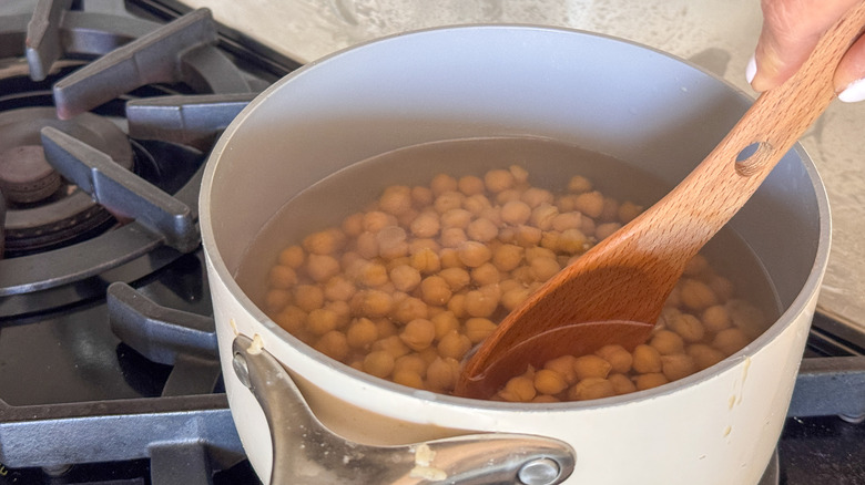 stirring chickpeas in pot