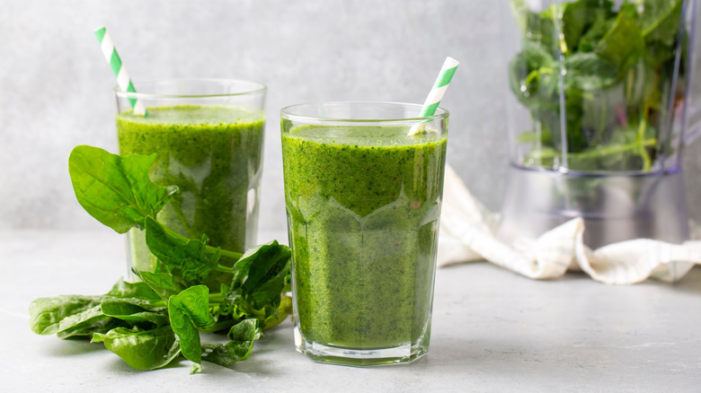 Spinach smoothies sitting on a counter