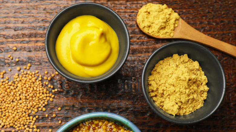 Mustard in various forms on a wooden table
