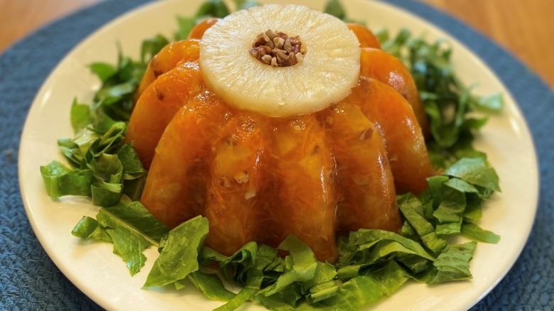 A gelatin mold with a pineapple ring atop a bed of lettuce