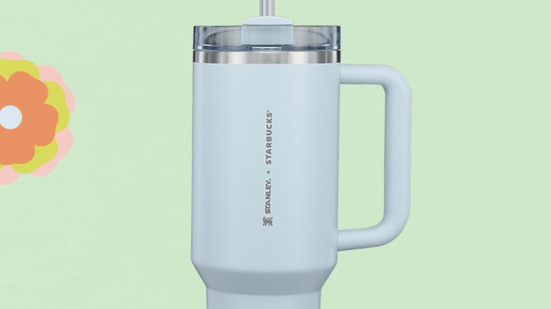 Sky blue 40-ounce Stanley x Starbucks cup on pastel green background.
