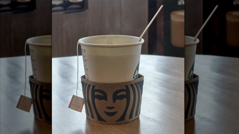 A hot tea from Starbucks sitting on a table