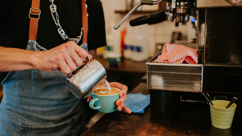 a barista makes a latte