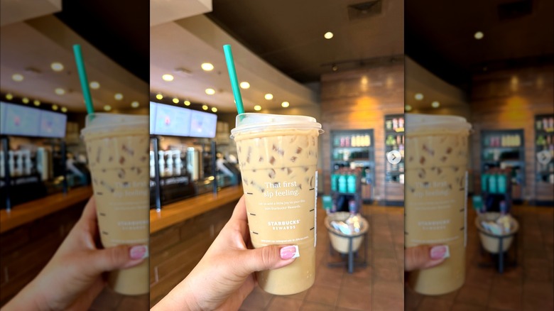 Hand holding a sweet cream cold brew with brown sugar