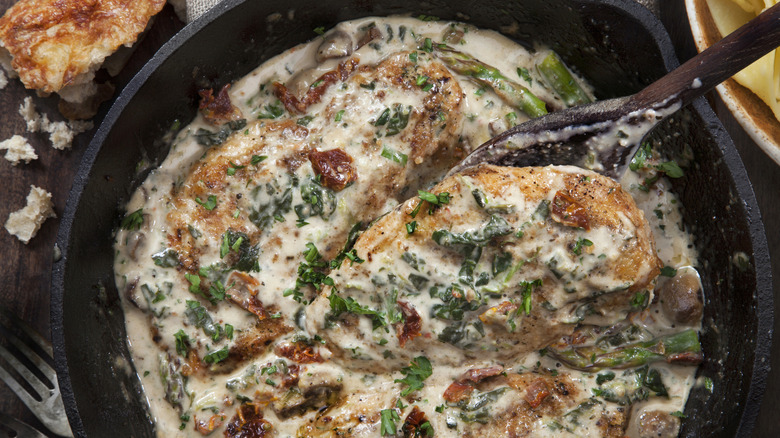 Creamy chicken with sauce and herbs