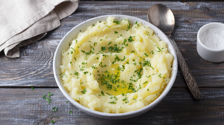 A plate of creamy mashed potatoes on a table