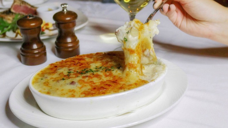 A bowl of three-cheese au gratin potatoes at The Palm Restaurant