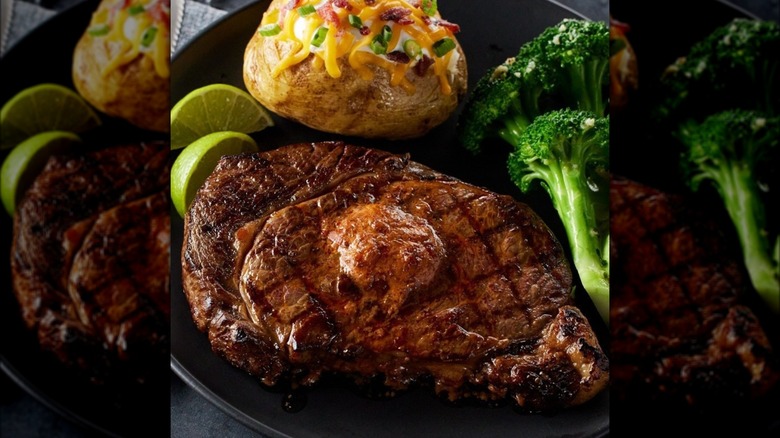 Steak, a loaded baked potato, and broccoli on a plate