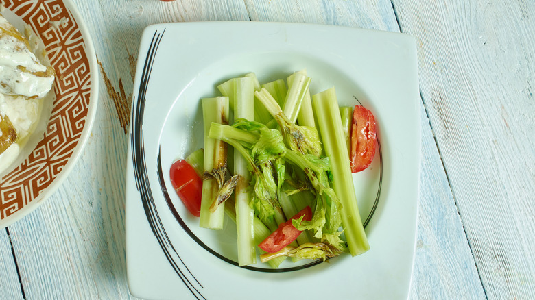 Celery Victor on a vintage plate with tomatoes