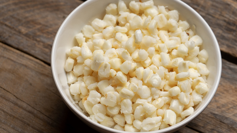 A white bowl of hominy.