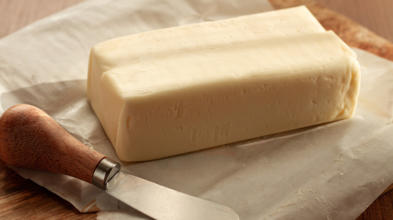 Slab of butter on paper on a cutting board