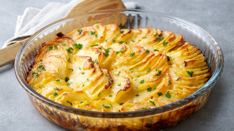 A tasty potato au gratin with a perfectly charred surface, served in a clear dish