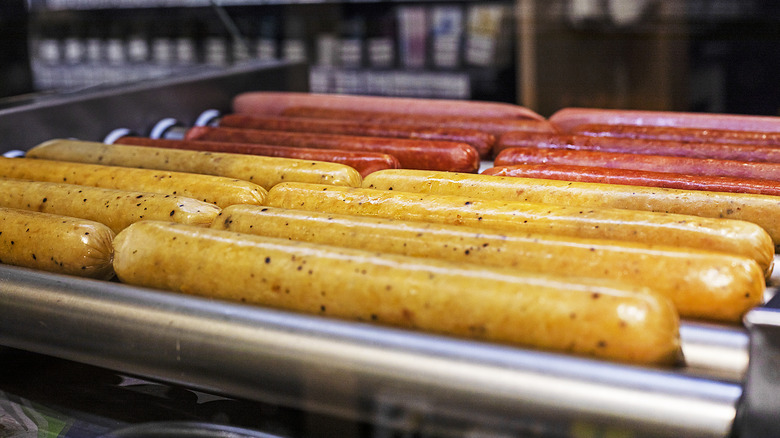 Hot dogs on a roller at a gas station