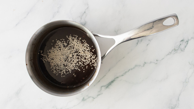 Garlic and ginger glaze with sesame seeds in saucepan