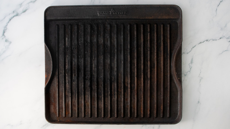 A large cast iron grill pan preheating