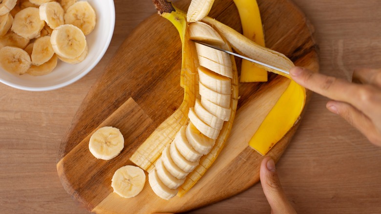 Person slicing banana