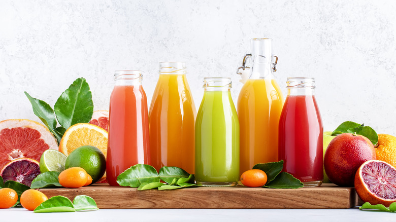 glass bottles full of fruit juices
