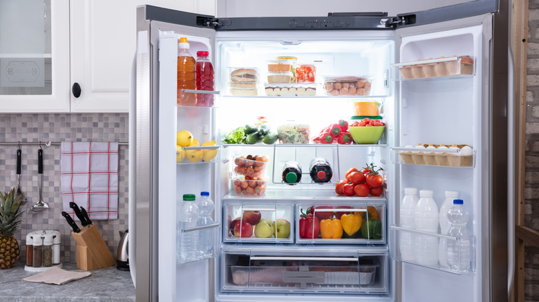 open stainless steel fridge with beverage bottles