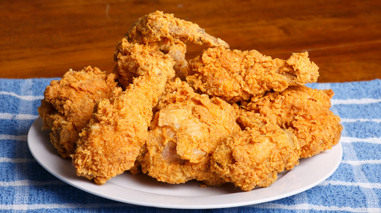Several pieces of fried chicken served in a white plate