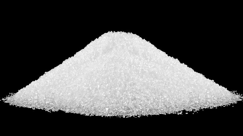 Pile of salt on black background