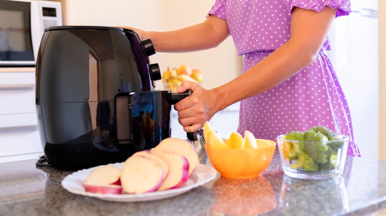 sliced vegetables beside air fryer