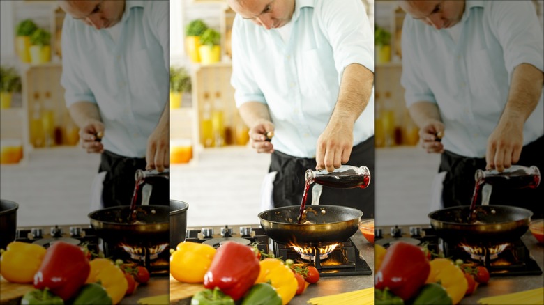 Man pouring wine into pan