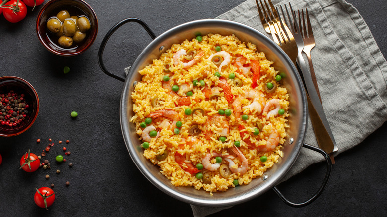 A vibrant paella dish served in a stainless bowl