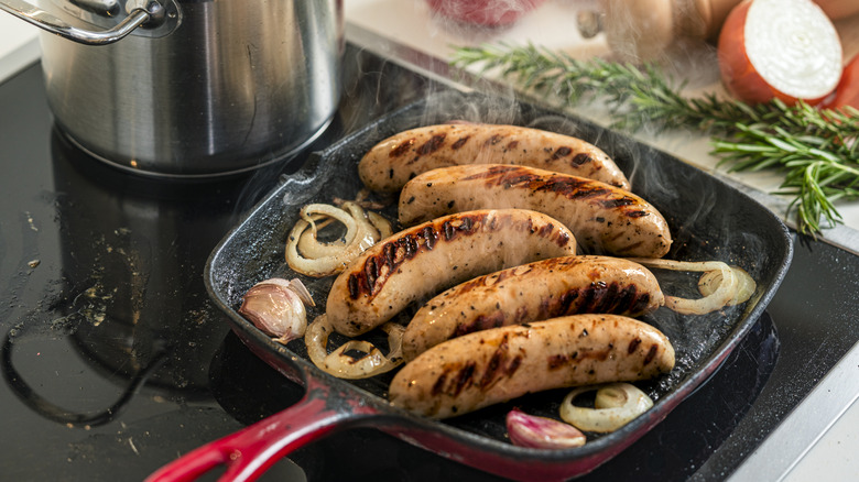 Sausages cooked in a pan with aromatics