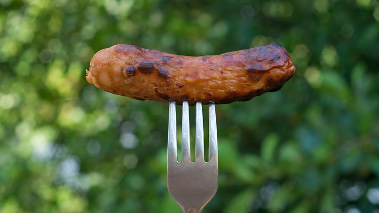 A fried sausage on a fork