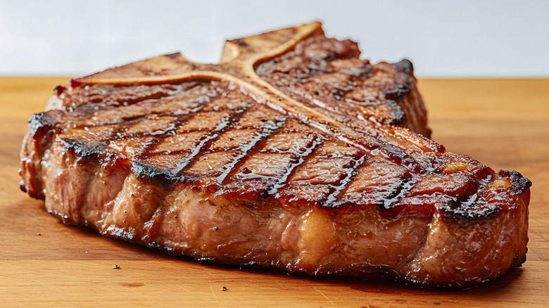 A juicy grilled T-bone steak resting on a cutting board