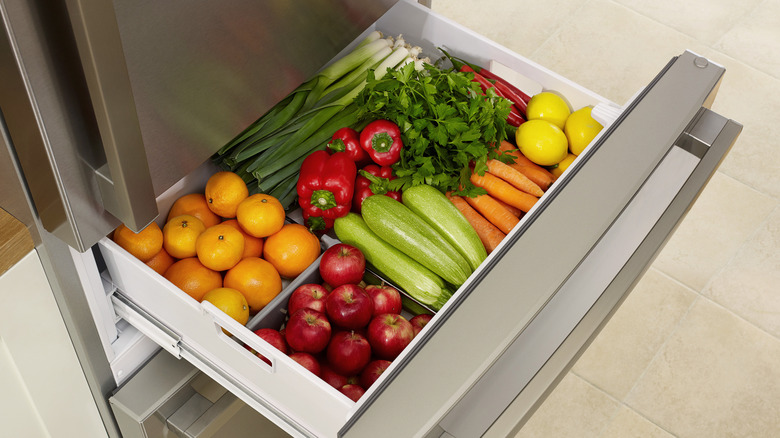 A fridge drawer with different produce grouped together