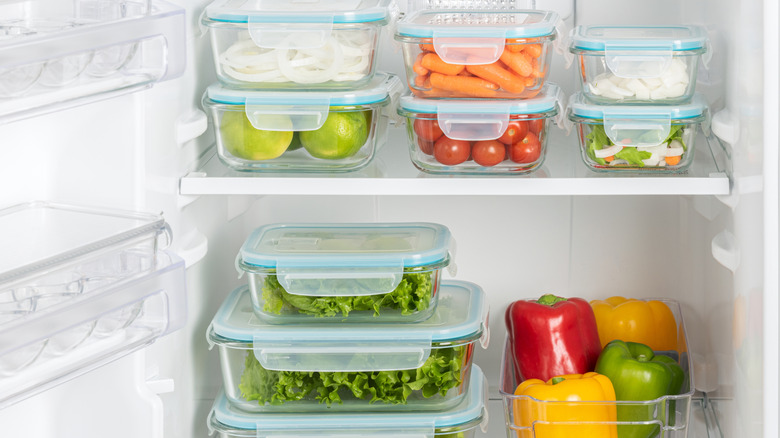 A clean and organized fridge filed with produce in airtight containers