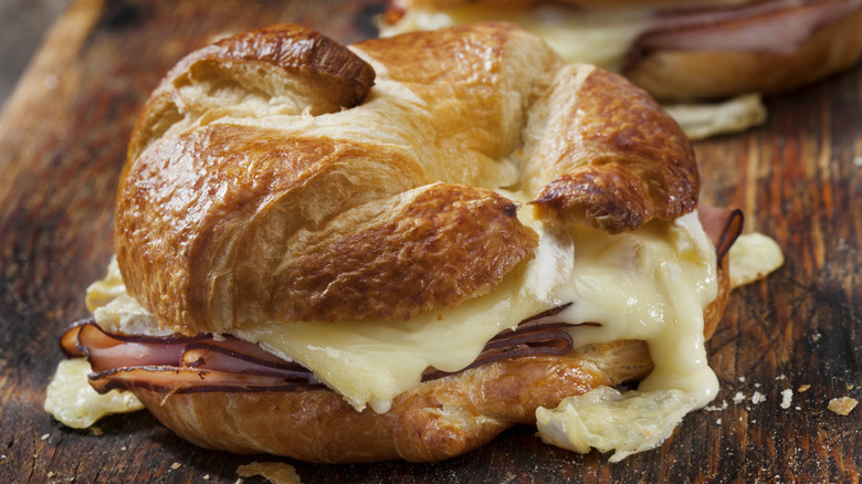 A croissant breakfast sandwich with cheese and ham