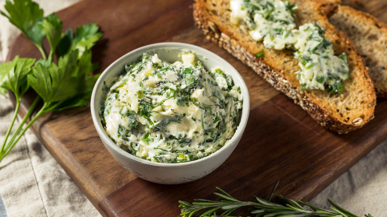 Herbed butter in a bowl with toast