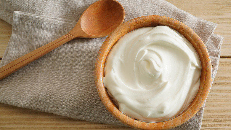 softened cream cheese in a wooden bowl