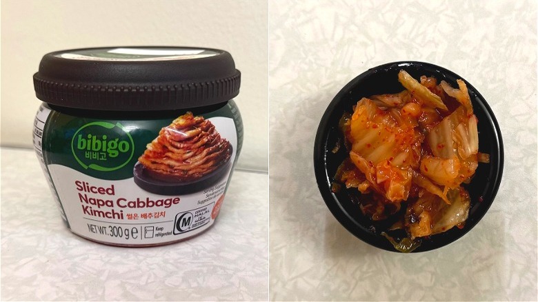 A small black dish of kimchi beside a Bibigo Sliced Napa Cabbage Kimchi jar