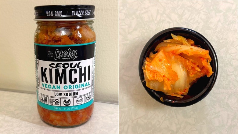 A small black dish of kimchi beside Lucky Foods Seoul Vegan Original Kimchi jar