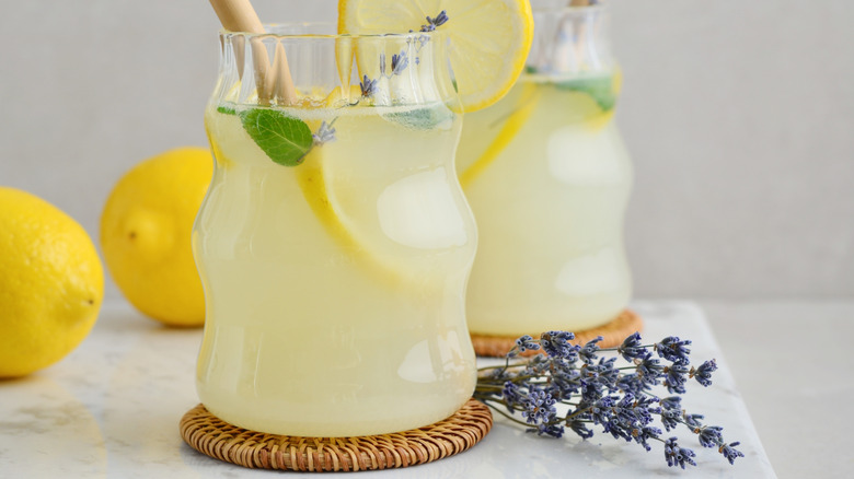 Two glasses of lemonade with mint and lavender.