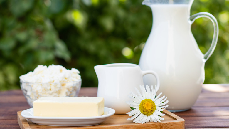 Milk and butter on a table.