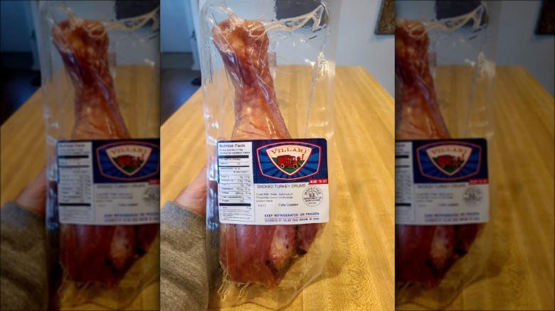 A person holding a vacuum-sealed turkey leg from Villari Brothers