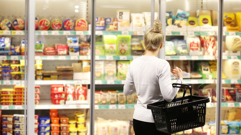 Woman shopping in the frozen food aisle