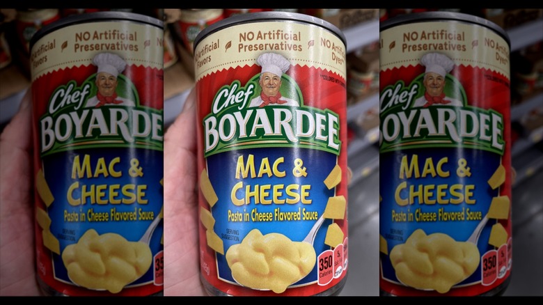 Hand holding a can of Chef Boyardee mac and cheese