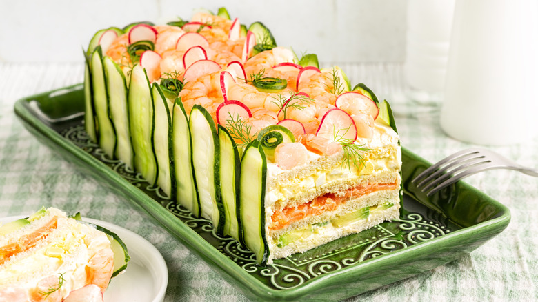 A Party Sandwich Loaf sits on a green serving dish