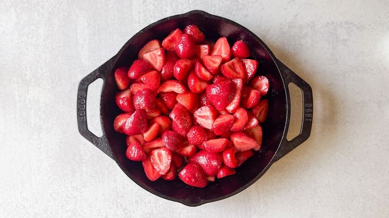 Strawberry cobbler filling in a cast iron skillet