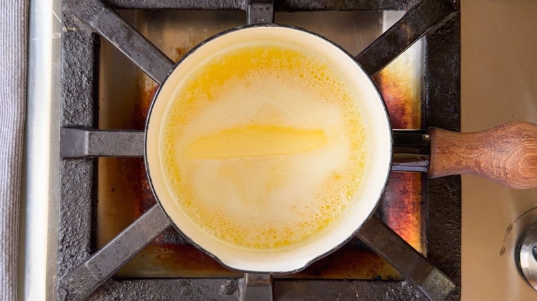 Butter melting in sauce pan on stovetop