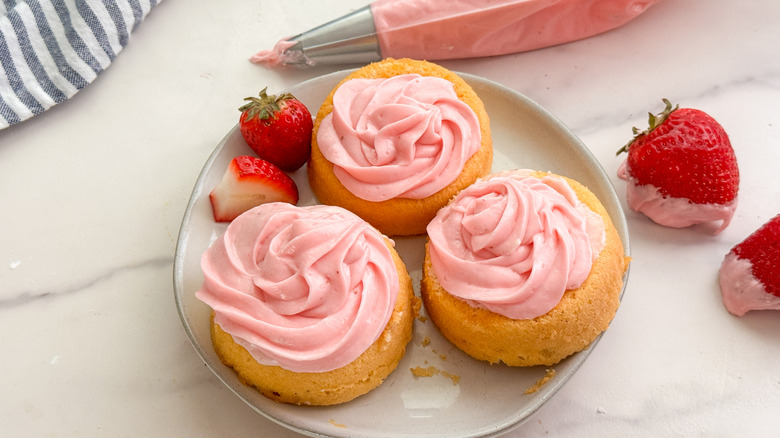 cupcakes topped with strawberry frosting