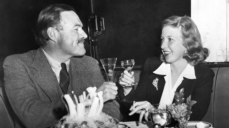 Ernest Hemingway and his wife drinking at a bar