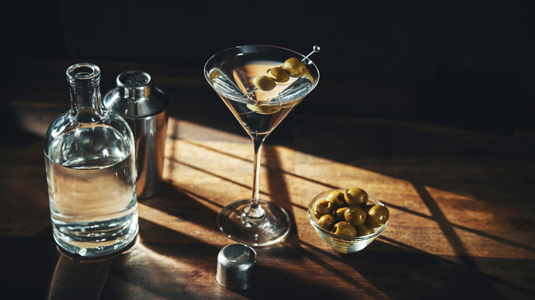 A martini with olive garnishes