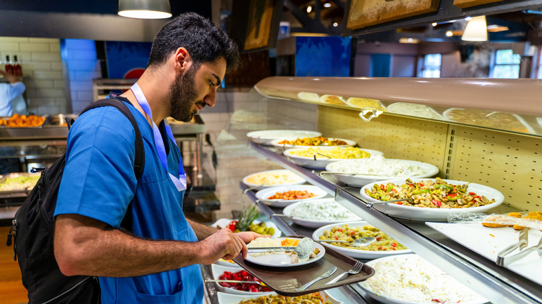 A man getting food at a dining hall